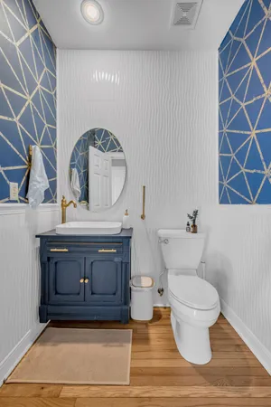 a bathroom with a sink a toilet and a mirror