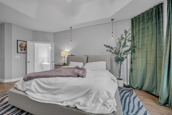 a bedroom with a bed and a potted plant