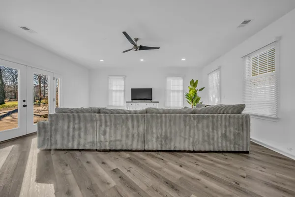 a living room with kitchen island furniture and a wooden floor