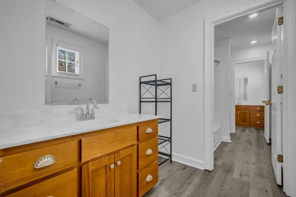 a bathroom with a sink a mirror and shower