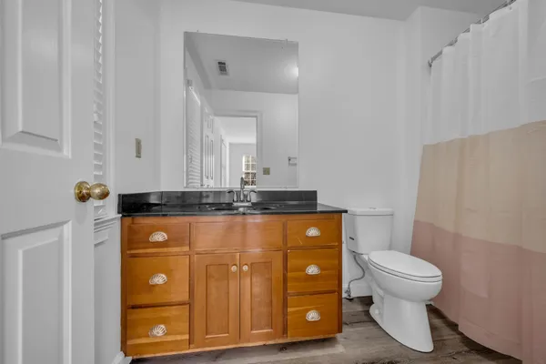 a bathroom with a sink a toilet and a mirror