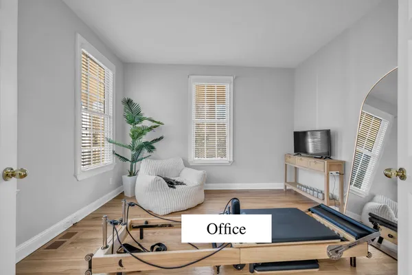 a living room with furniture and a wooden floor