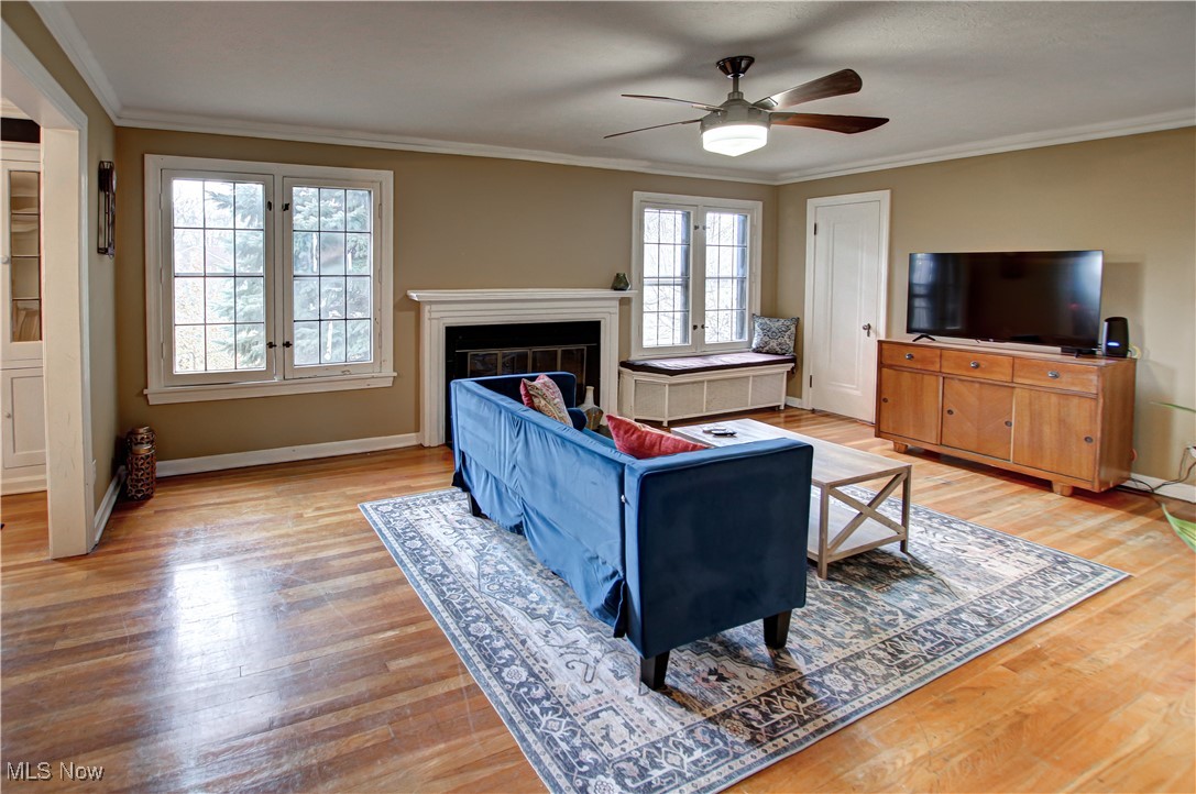 17800 Winslow Road Beachwood, OH 44122 - Photo 21 of 31 Living room with ornamental molding, light wood-type flooring, ceiling fan, and a healthy amount of sunlight