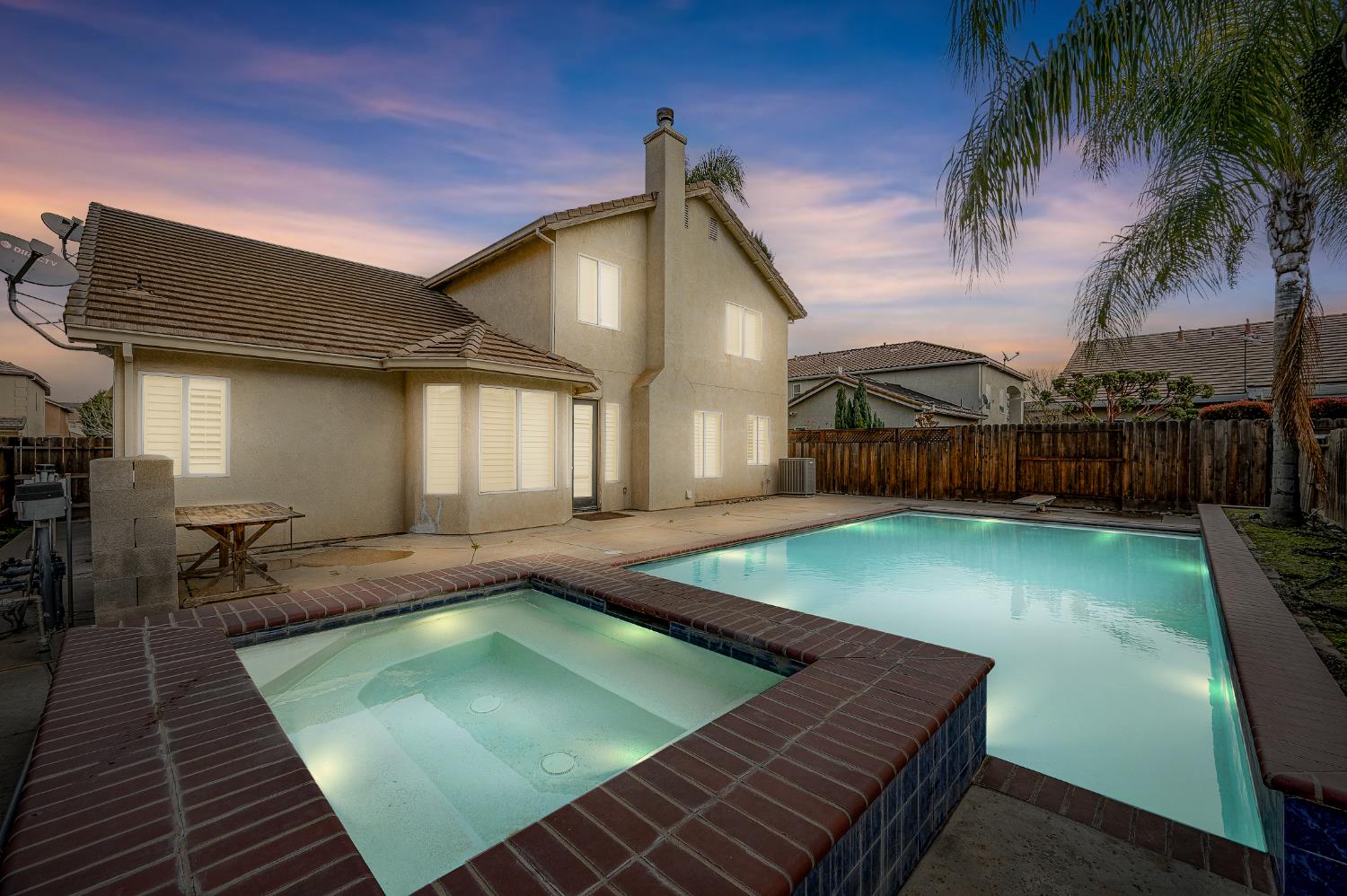 a view of a backyard with swimming pool