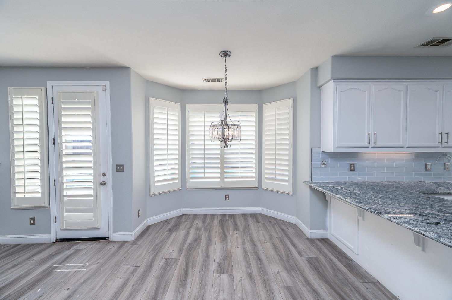 2800 Olympus Court Modesto, CA 95356 - Photo 19 of 56 an empty room with wooden floor and windows