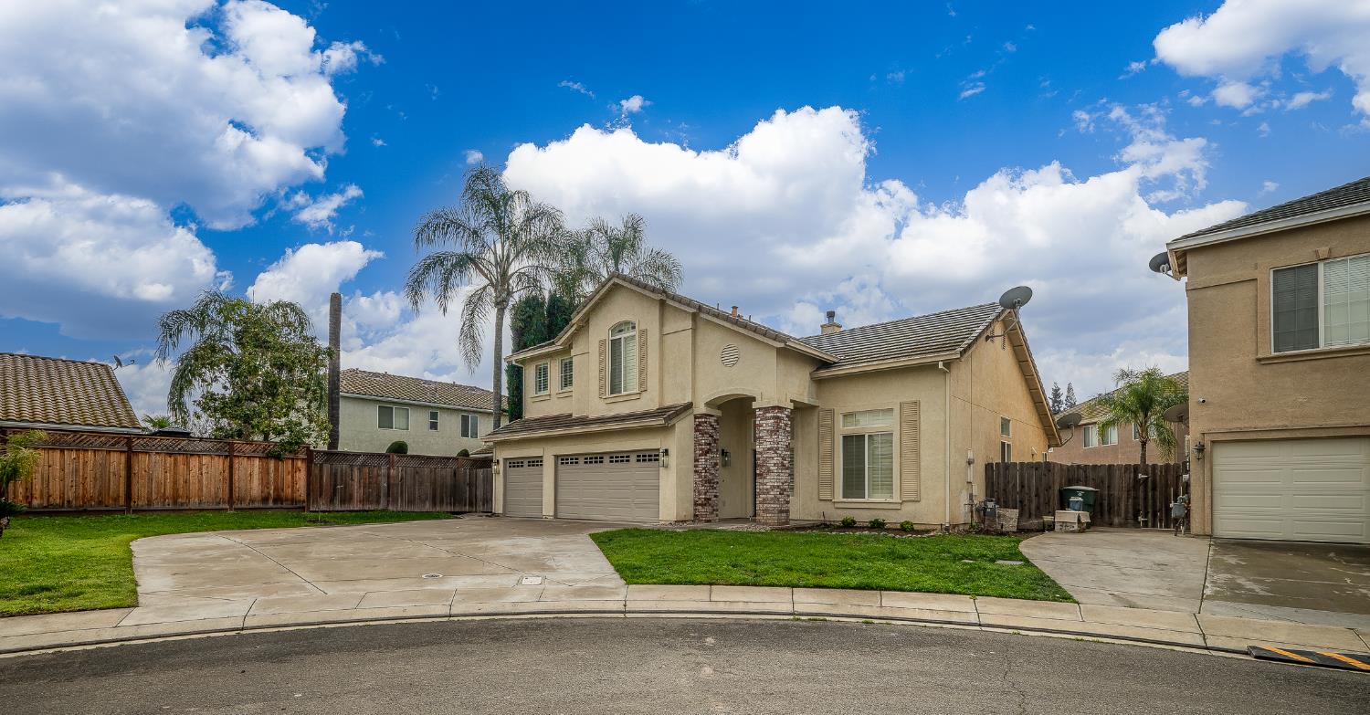 2800 Olympus Court Modesto, CA 95356 - Photo 6 of 56 a view of a white house with a yard