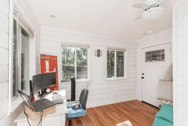 a workspace with furniture hardwood and a window