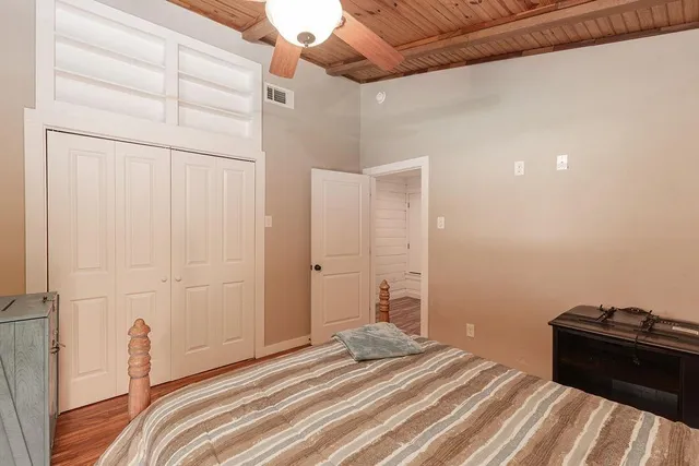 a bedroom with a bed and a mirror