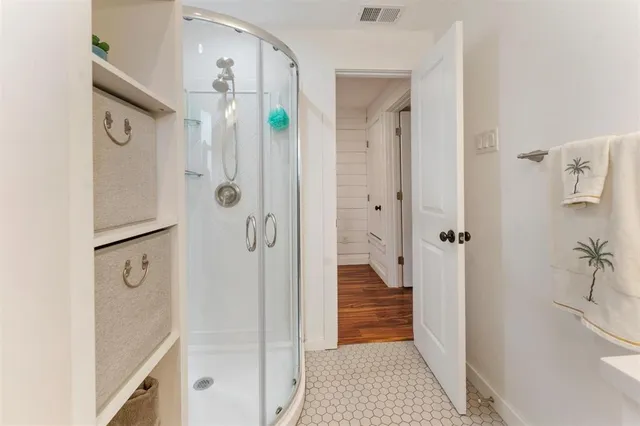 a bathroom with a shower and a sink