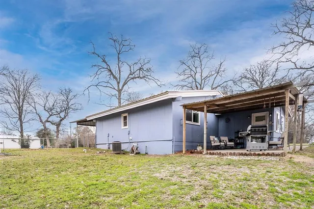 a view of a house with a yard and garage