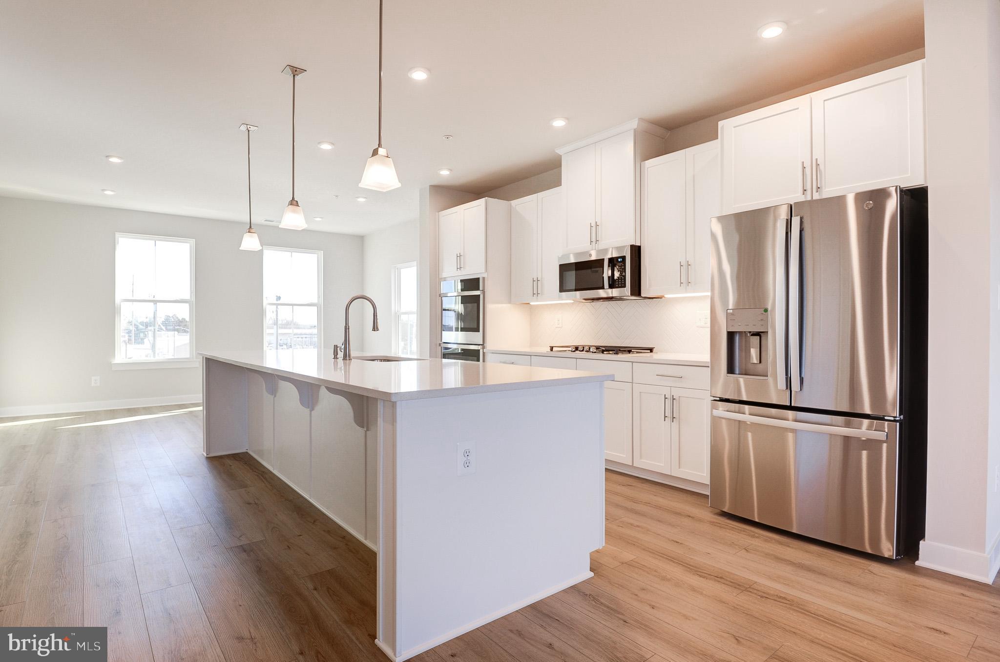 8020 Williamson Boulevard Manassas, VA 20109 - Photo 1 of 53 a kitchen with kitchen island white cabinets and stainless steel appliances