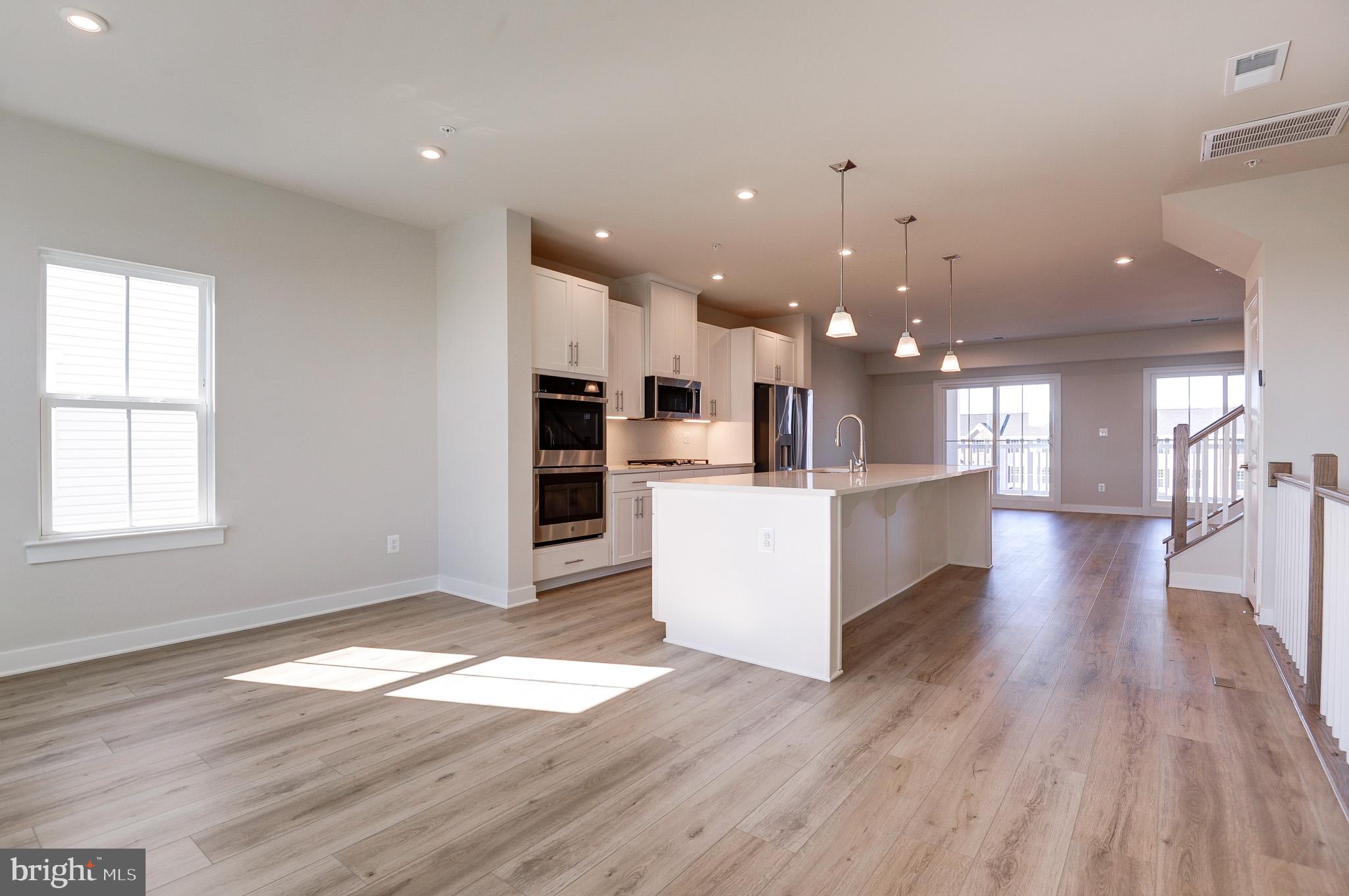 8020 Williamson Boulevard Manassas, VA 20109 - Photo 11 of 53 a view of a kitchen with furniture and wooden floor