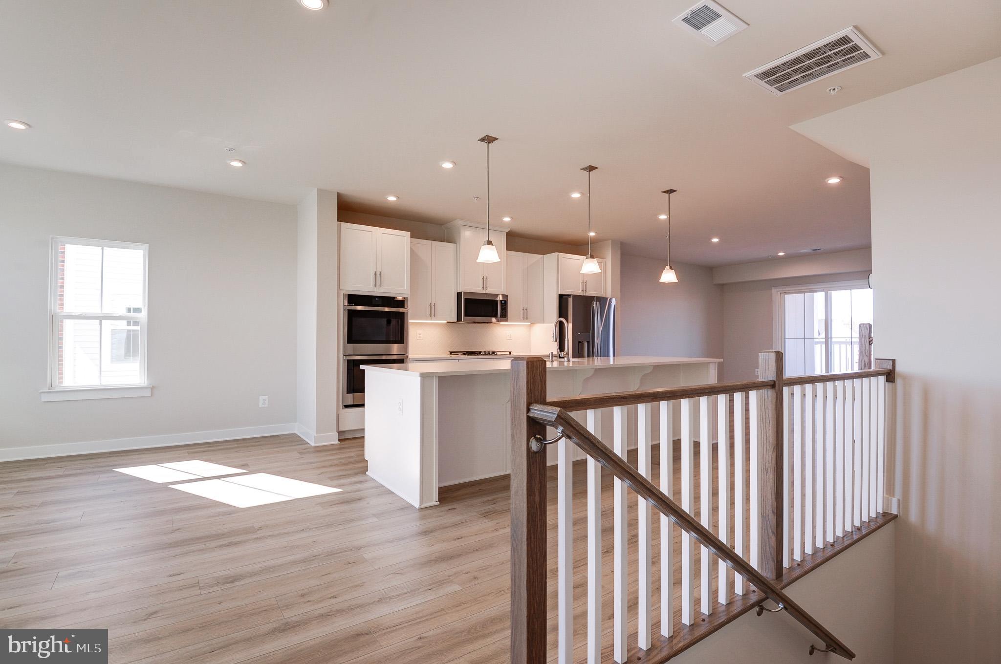8020 Williamson Boulevard Manassas, VA 20109 - Photo 12 of 53 a view of kitchen with wooden floor and electronic appliances