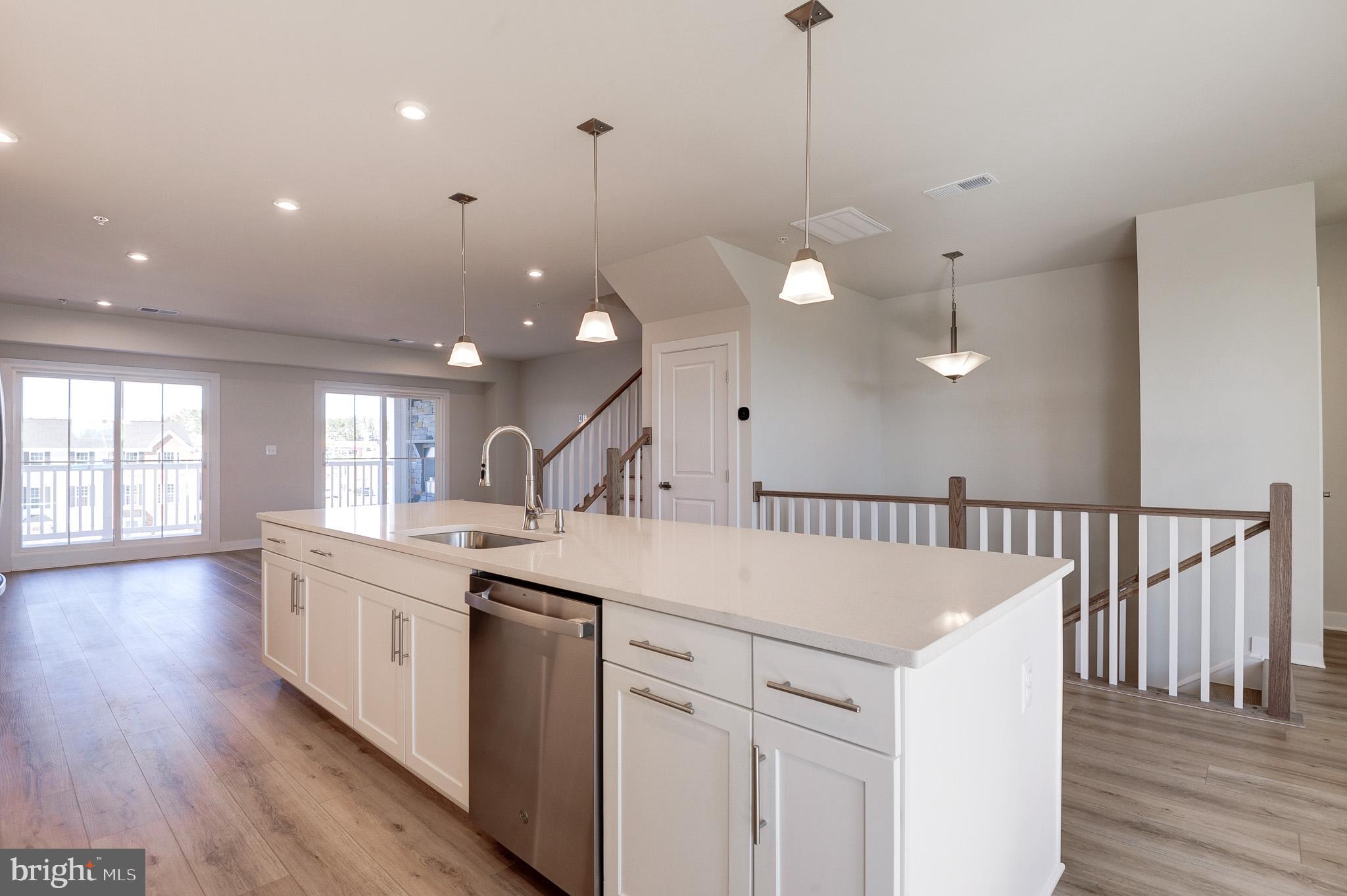 8020 Williamson Boulevard Manassas, VA 20109 - Photo 13 of 53 a kitchen with a sink and dishwasher with wooden floor