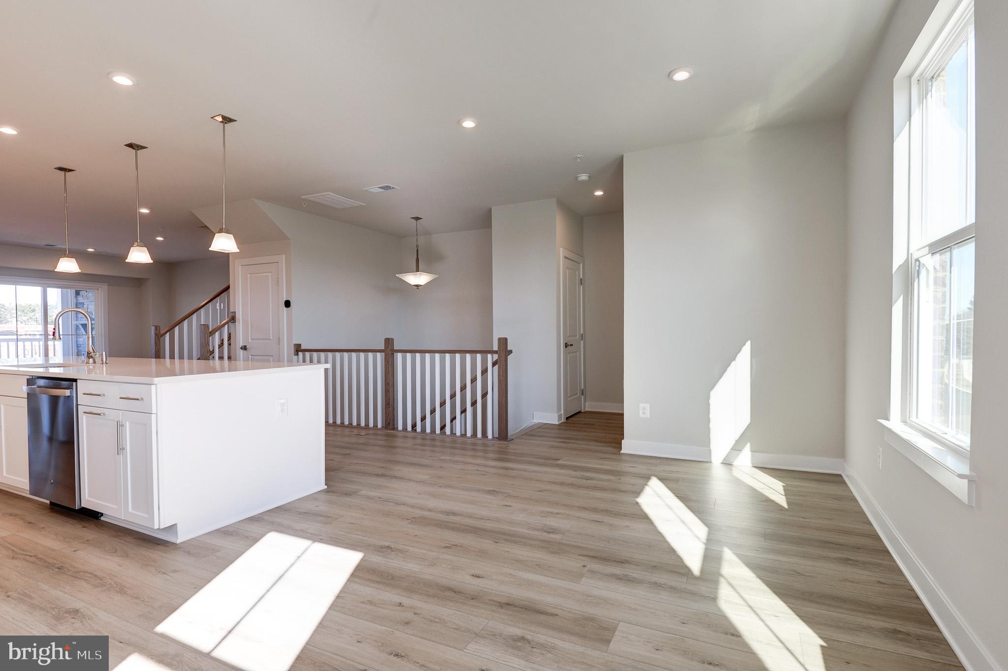 8020 Williamson Boulevard Manassas, VA 20109 - Photo 16 of 53 a view of a living room and kitchen with furniture wooden floor and window