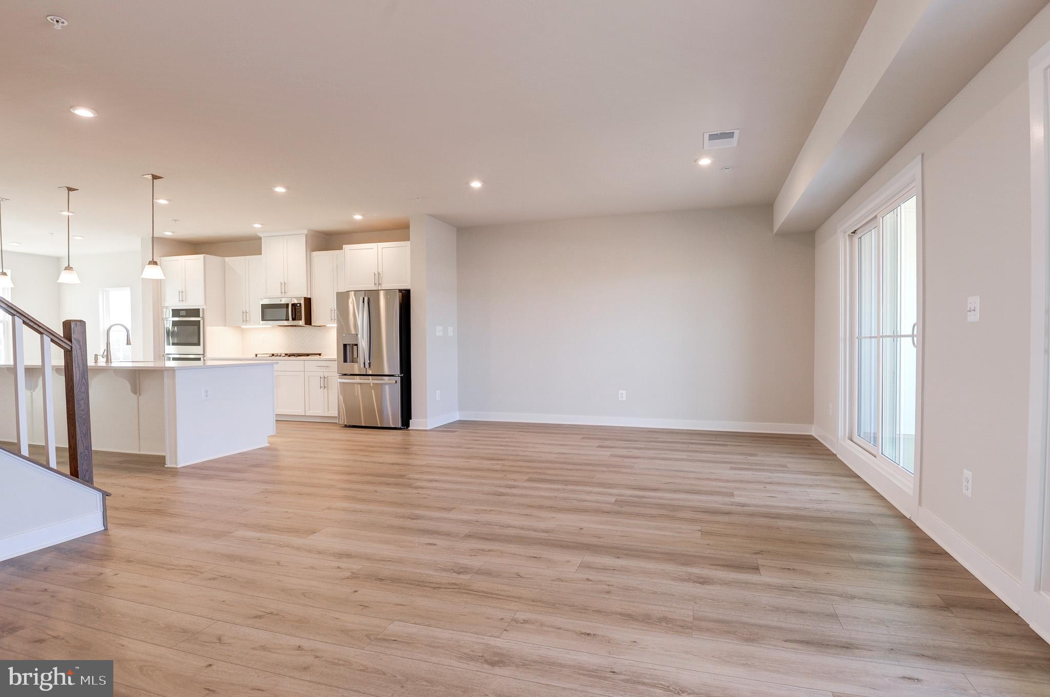 8020 Williamson Boulevard Manassas, VA 20109 - Photo 17 of 53 a view of kitchen with kitchen island wooden floor granite counter tops and a view living room