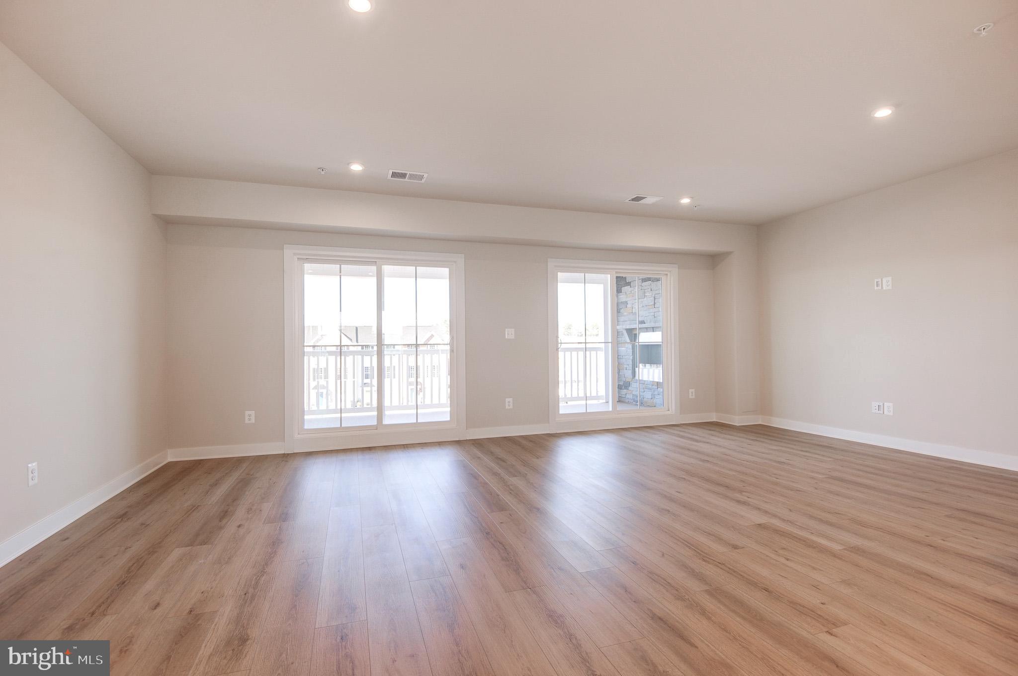8020 Williamson Boulevard Manassas, VA 20109 - Photo 20 of 53 a view of an empty room with wooden floor and a window
