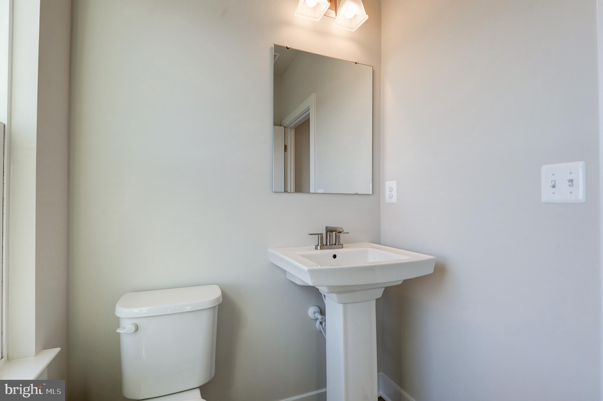 8020 Williamson Boulevard Manassas, VA 20109 - Photo 23 of 53 a bathroom with a sink a mirror and toilet