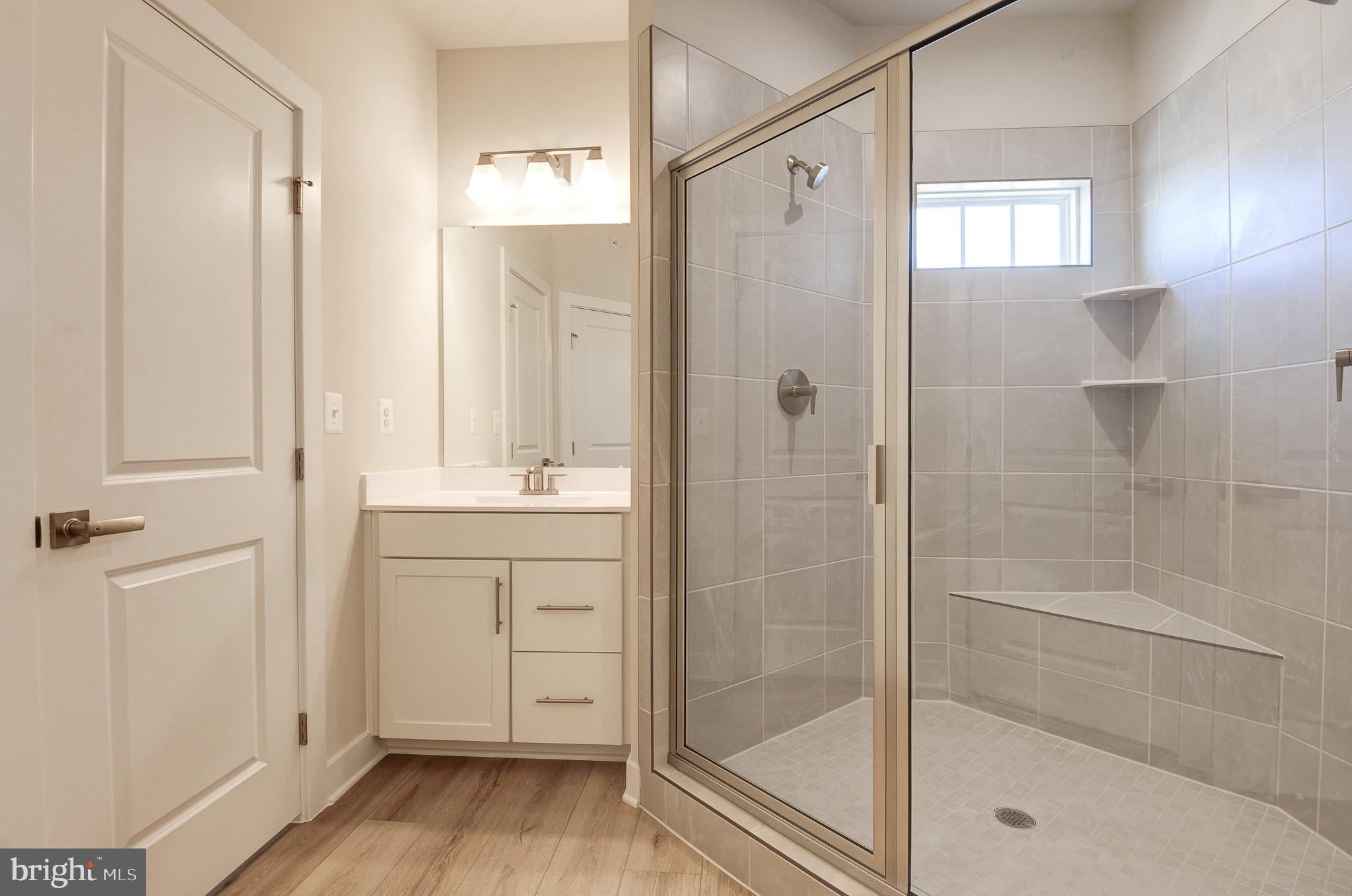 8020 Williamson Boulevard Manassas, VA 20109 - Photo 32 of 53 a bathroom with a shower sink and mirror