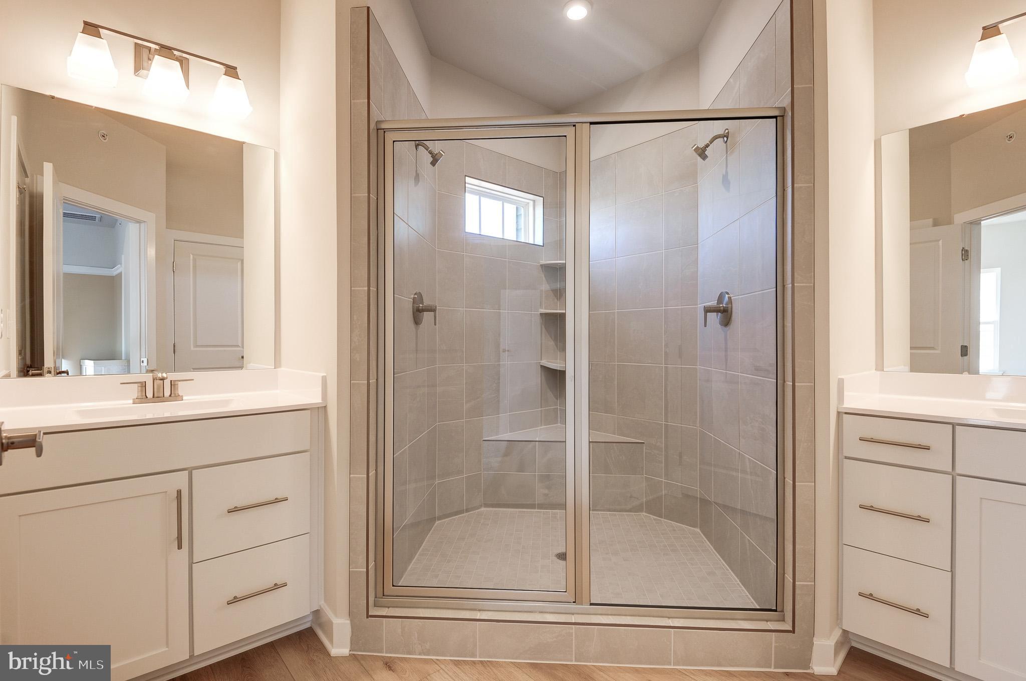 8020 Williamson Boulevard Manassas, VA 20109 - Photo 33 of 53 a bathroom with a shower sink and mirror