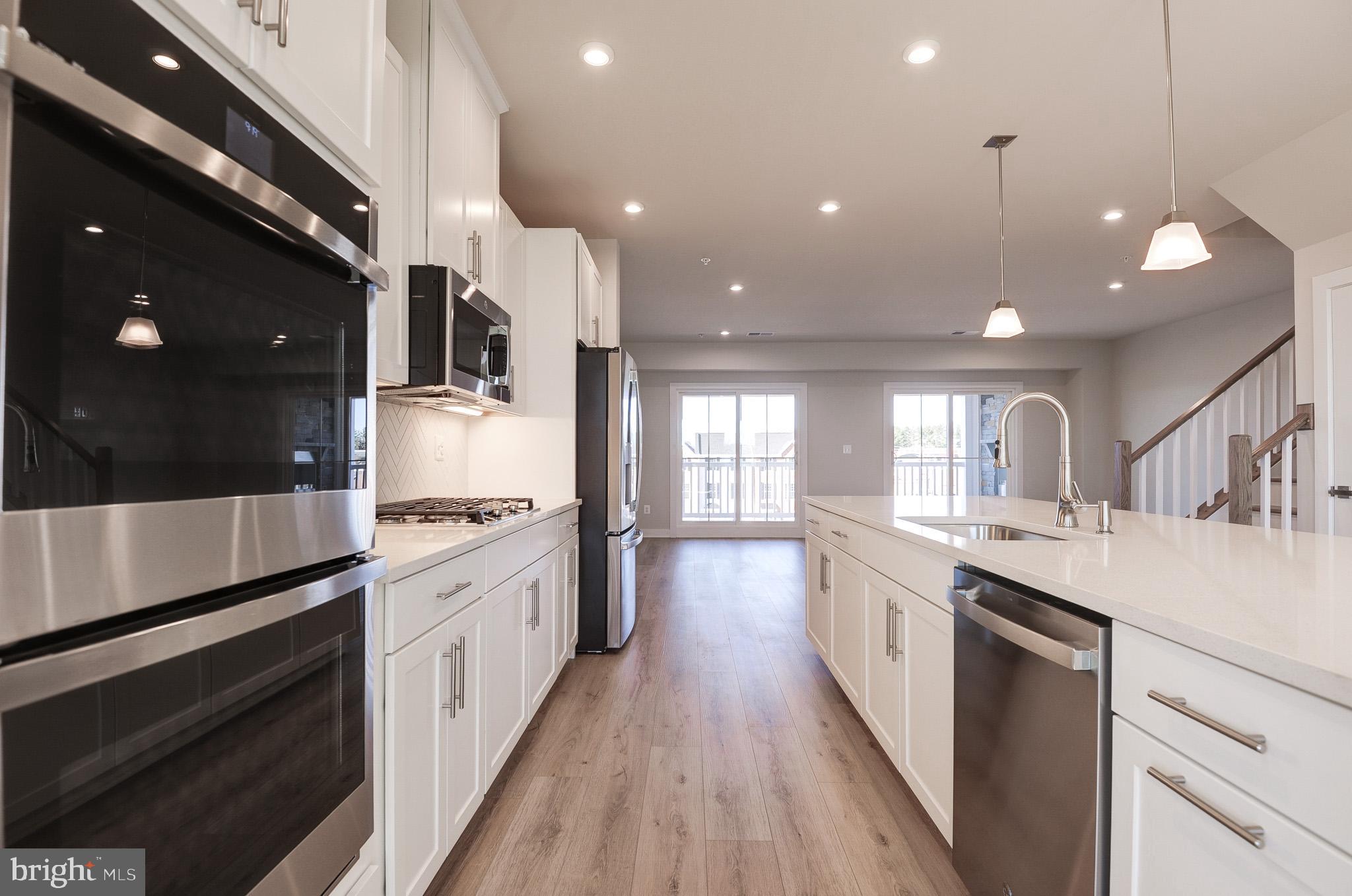 8020 Williamson Boulevard Manassas, VA 20109 - Photo 9 of 53 a large kitchen with stainless steel appliances lots of counter space and wooden floor