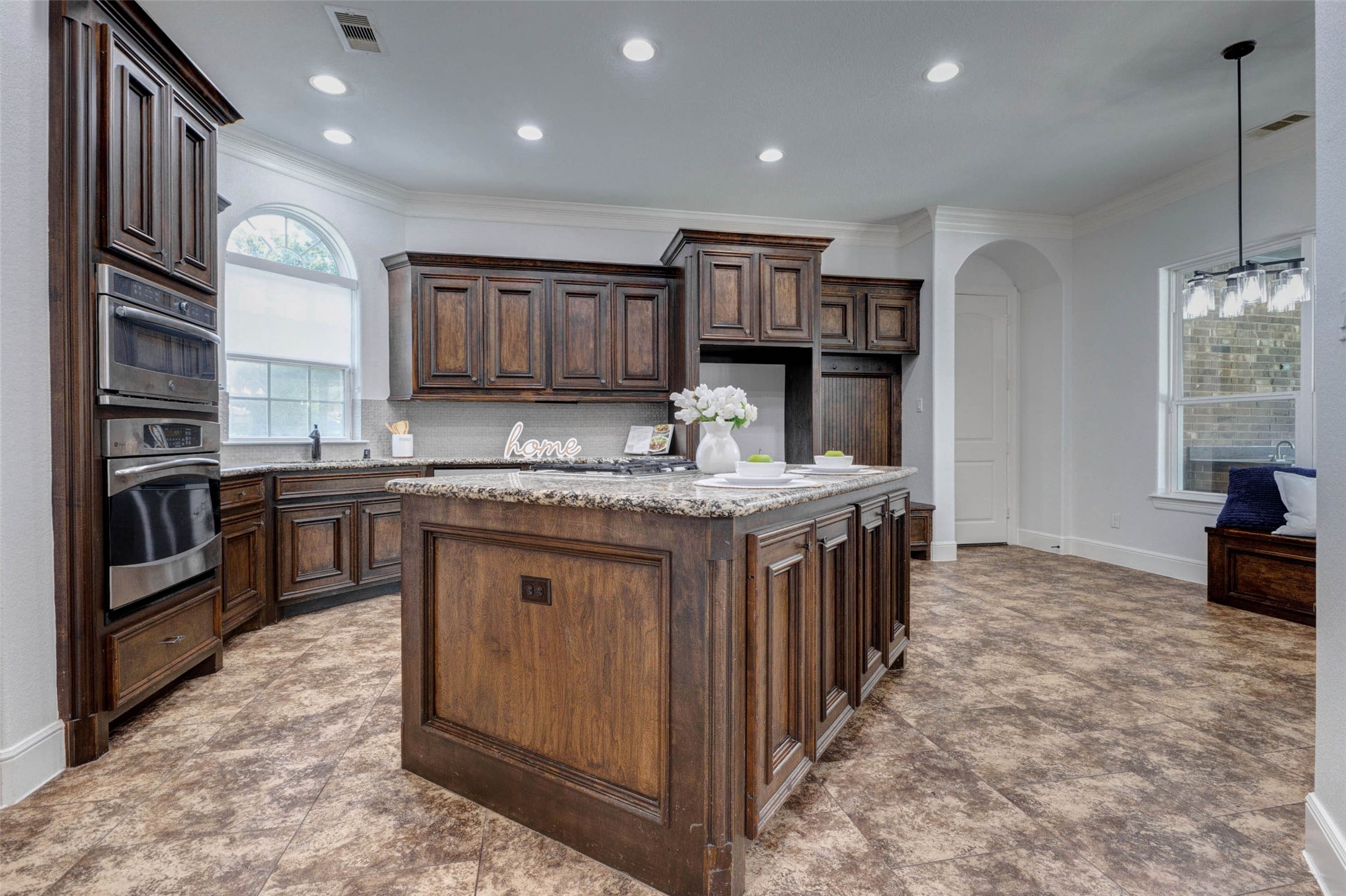 5327 Whitmore Fulshear, TX 77441 - Photo 7 of 50 The gourmet kitchen is truly the heart of the home, featuring rich custom cabinetry, granite countertops, quality appliances, and a spacious center island