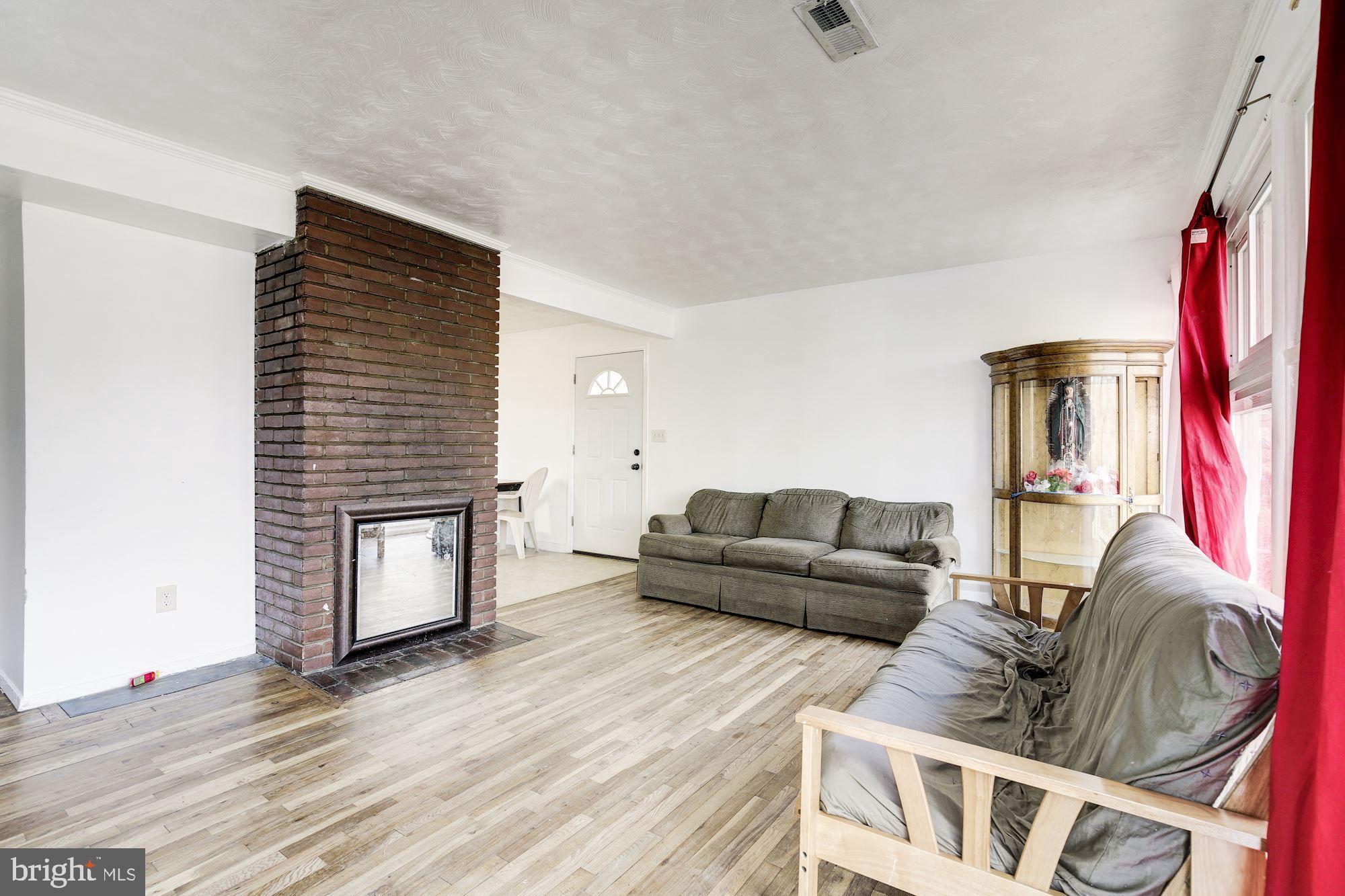 5705 Denfield Road Rockville, MD 20851 - Photo 11 of 20 a living room with furniture and a wooden floor