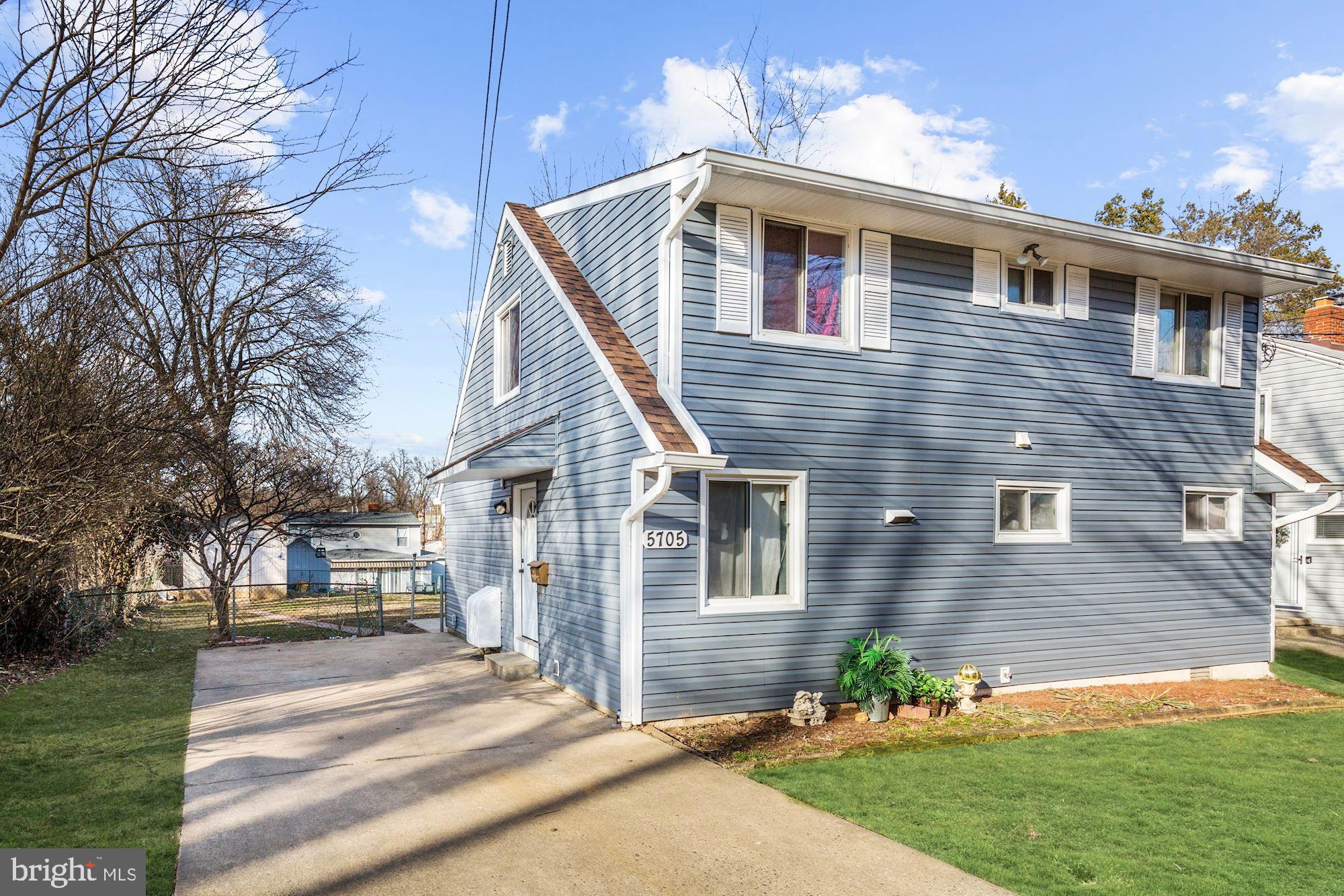 5705 Denfield Road Rockville, MD 20851 - Photo 17 of 20 a front view of a house with a yard