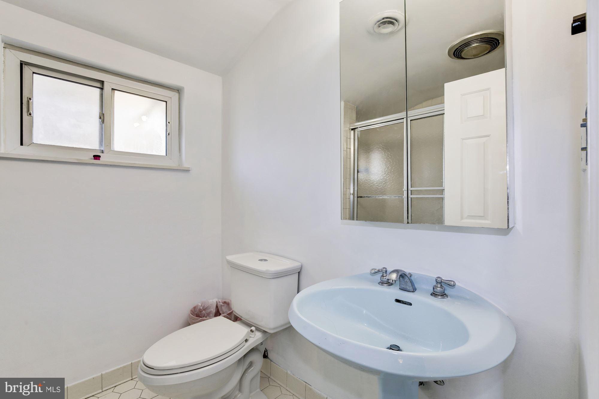 5705 Denfield Road Rockville, MD 20851 - Photo 19 of 20 a bathroom with a sink toilet and mirror