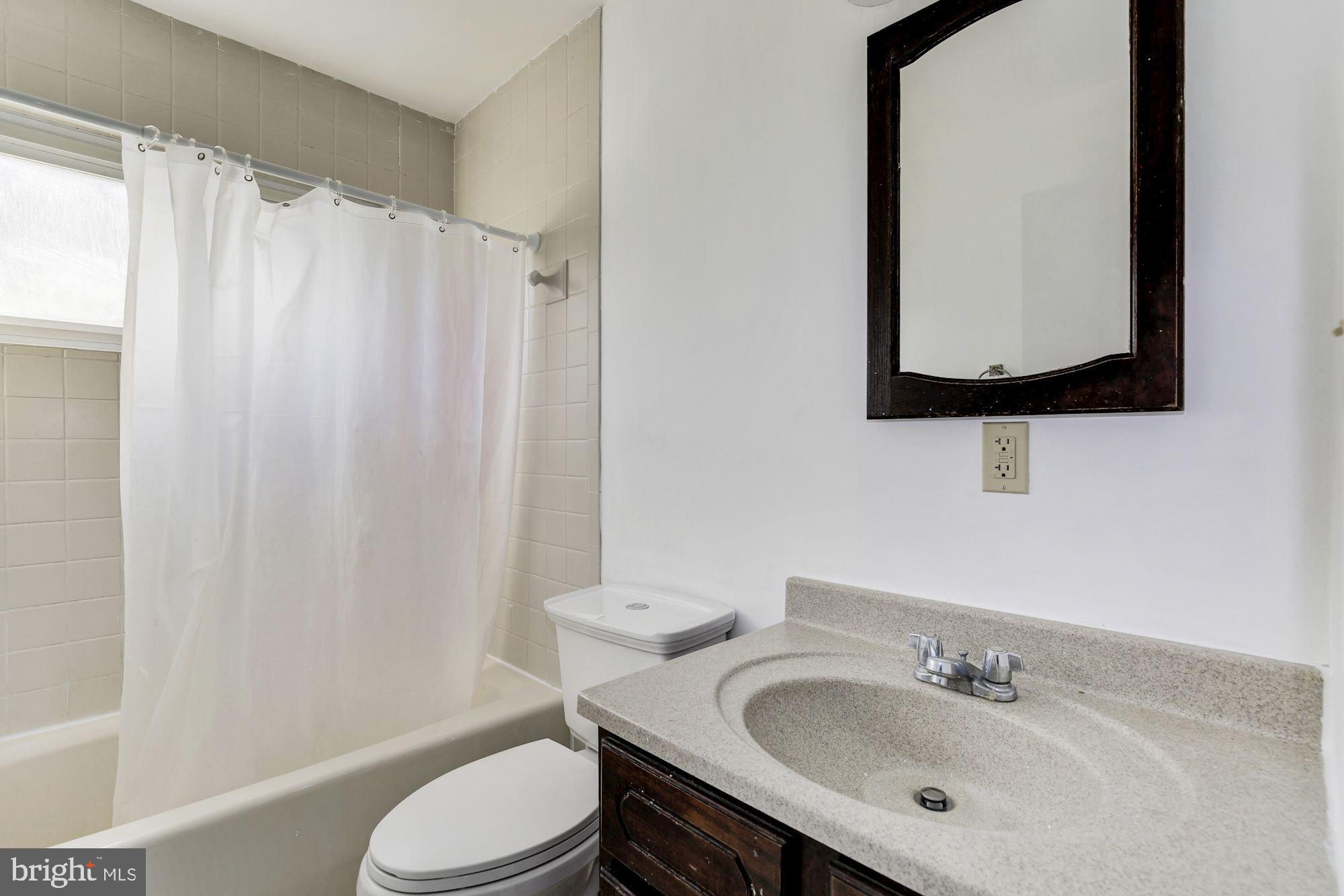 5705 Denfield Road Rockville, MD 20851 - Photo 20 of 20 a bathroom with a sink toilet and mirror