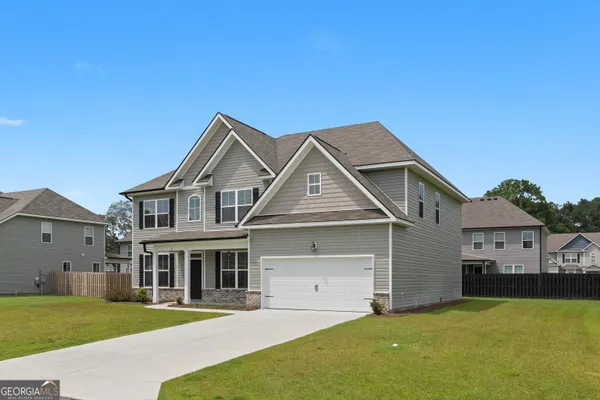 a front view of a house with a yard and garage