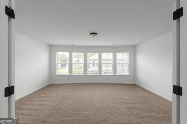 a view of an empty room with a window