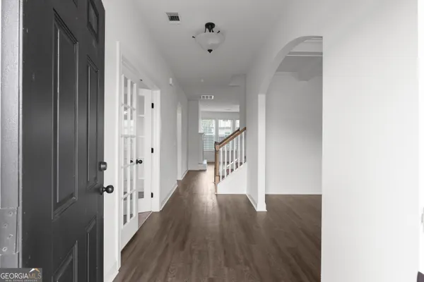 a view of a hallway with wooden floor