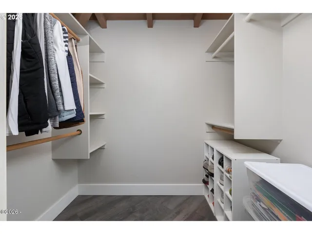 a bedroom with a large bed and a large window