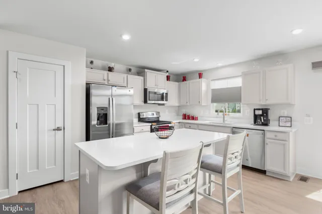 a bathroom with a toilet a sink a mirror and a shower