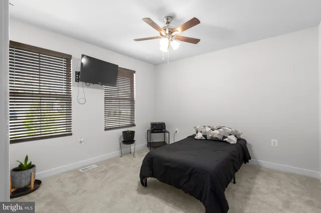 a bedroom with a bed and a couch