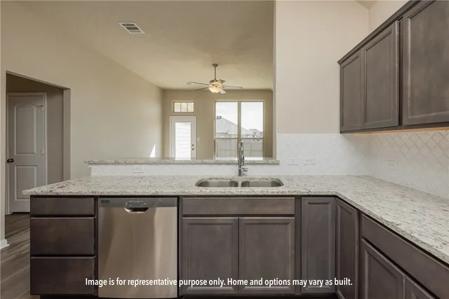 a kitchen with a sink a counter space and cabinets