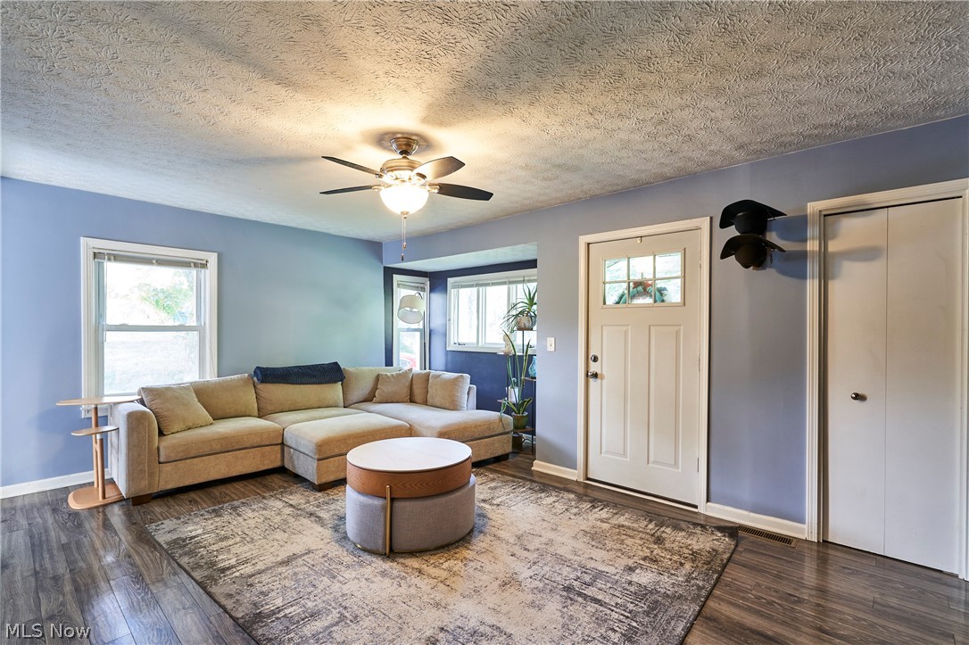 6586 Red Brush Road Ravenna, OH 44266 - Photo 2 of 27 Spacious living room, with newer LVT flooring, ceiling fan and newer front door