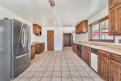 a view of an empty room with window and fireplace