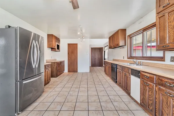 a view of an empty room with window and fireplace