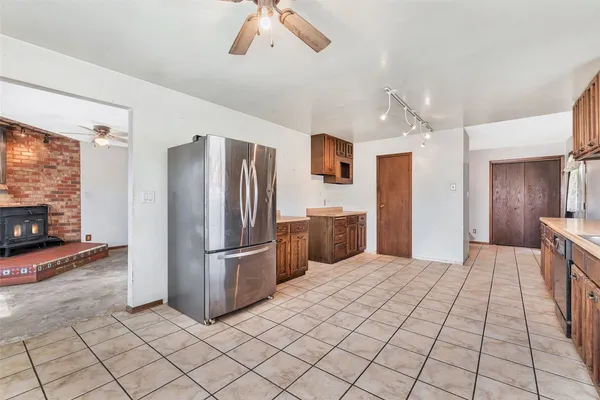 an empty room with windows and fireplace