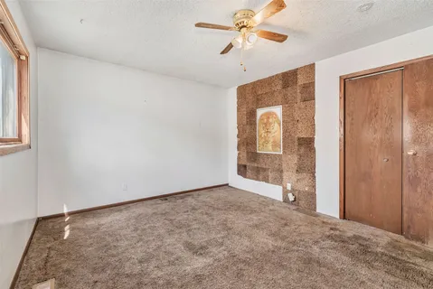 a bathroom with a granite countertop toilet a sink and a mirror