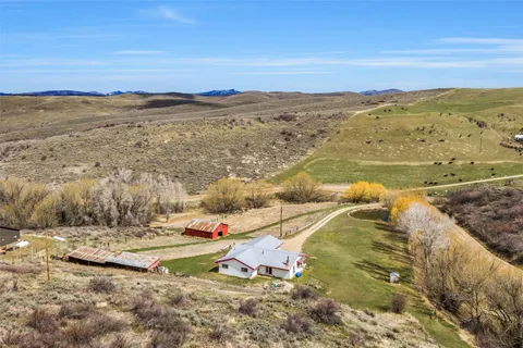 a large kitchen with a large window and stainless steel appliances