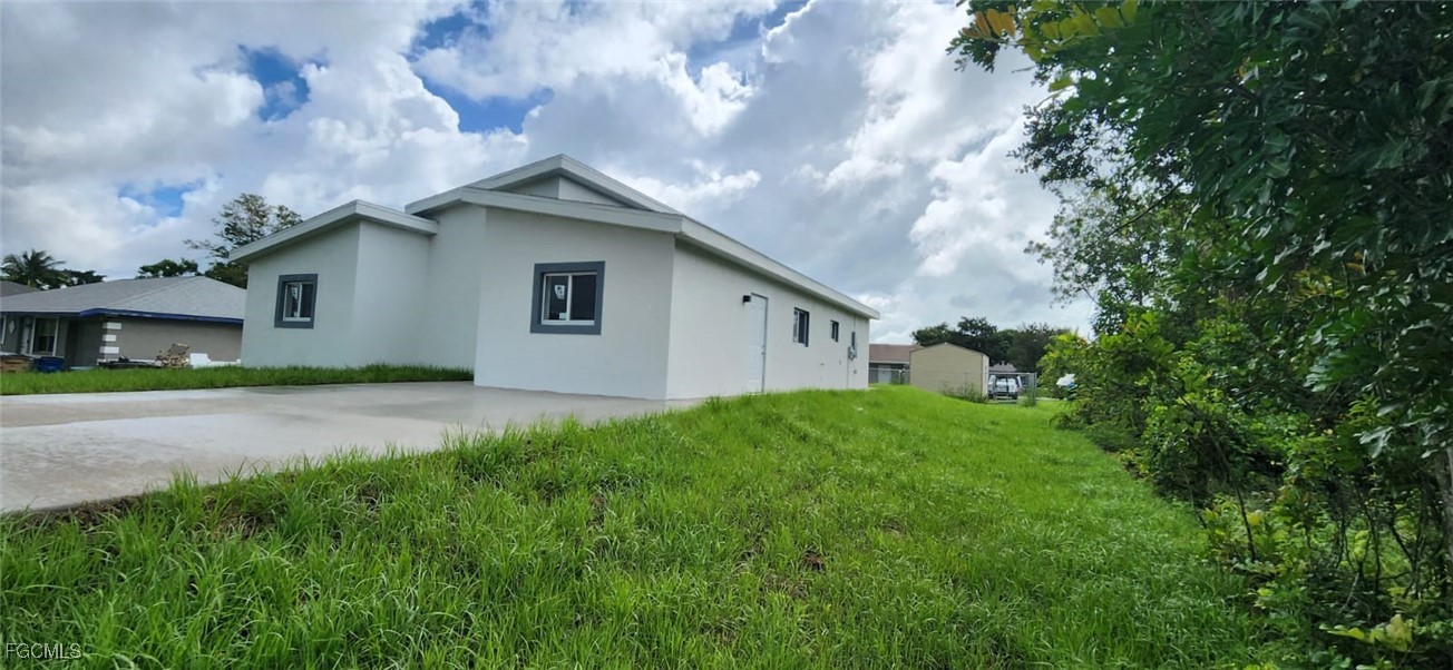 a house with green field in front of it