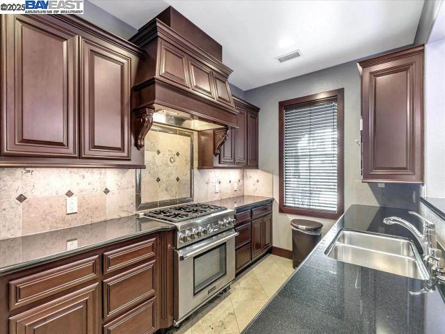 3275 Dublin Boulevard, Unit 408 Dublin, CA 94568 - Photo 38 of 52 a kitchen with stainless steel appliances granite countertop a sink stove and cabinets