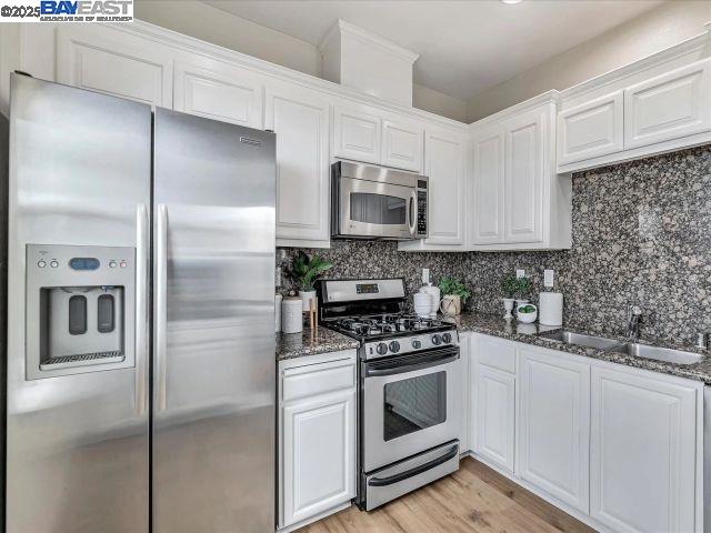 3275 Dublin Boulevard, Unit 408 Dublin, CA 94568 - Photo 52 of 52 a kitchen with stainless steel appliances cabinets a sink and a counter top space