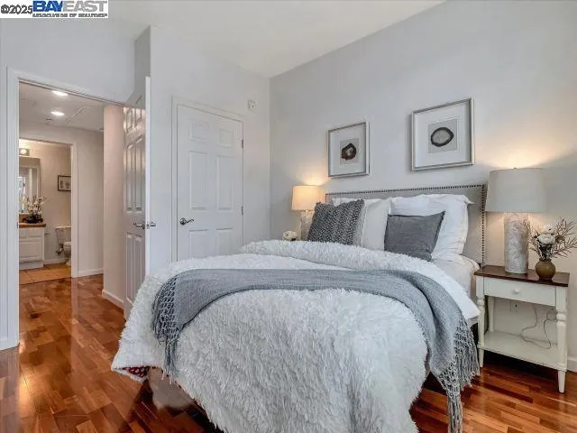 a bedroom with a bed and wooden floor