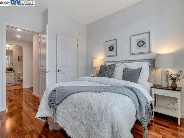 3275 Dublin Boulevard, Unit 408 Dublin, CA 94568 - Photo 6 of 52 a bedroom with a bed and wooden floor