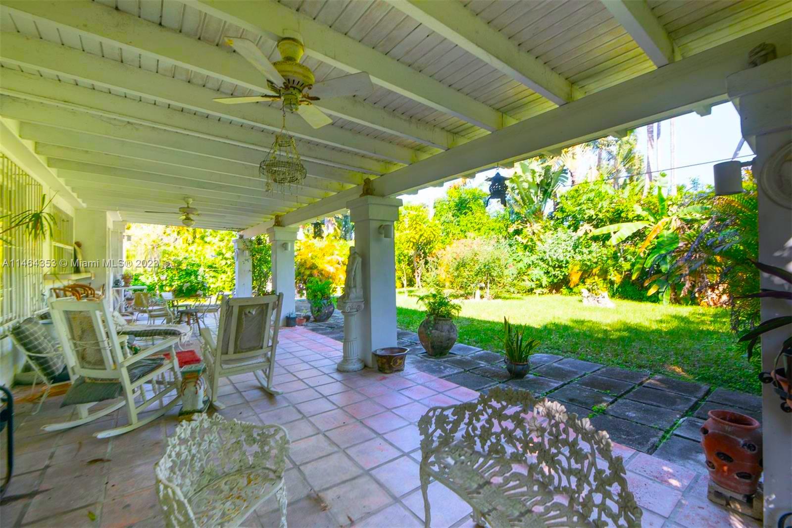 4505 Alton Road Miami Beach, FL 33140 - Photo 4 of 9 a view of a porch with chairs and a backyard