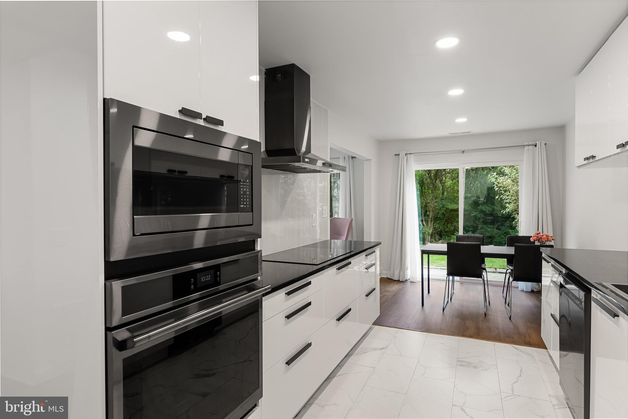 a kitchen with stainless steel appliances kitchen island granite countertop a stove and a sink